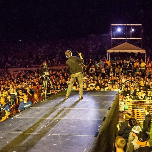 Crowd surrounding the stage at night during the Uprise Festival