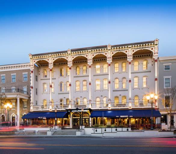 Adelphi Hotel at dusk with lights on