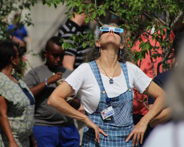 Woman looking up using eclipse viewing glasses at the Rochester Museum & Science Center during the 2017 Total Solar Eclipse