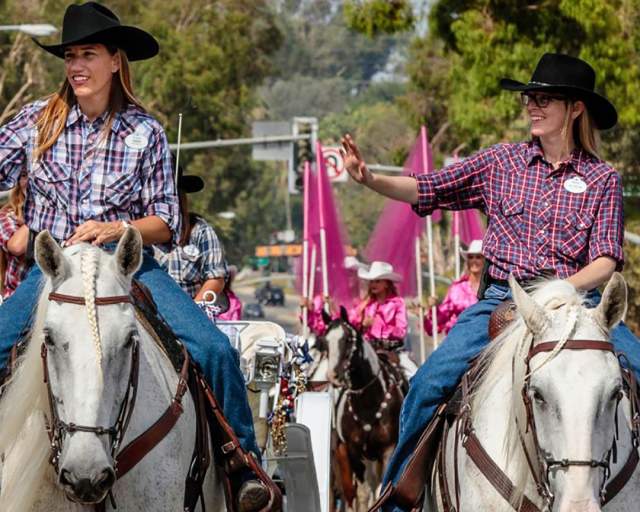 Two women riding horses in the rodeo parade in Norco, CA