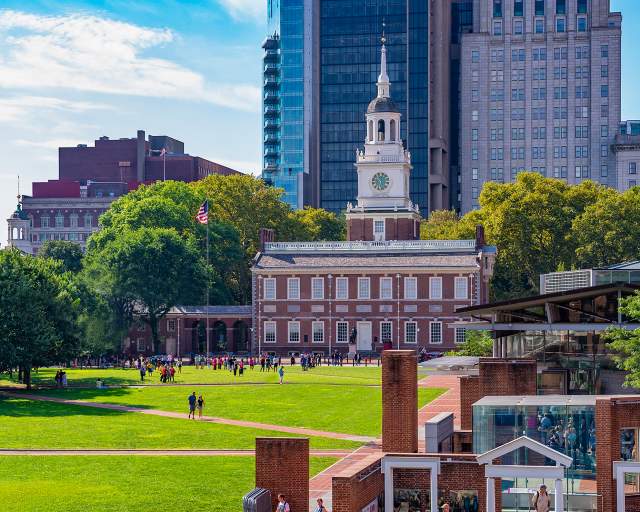 A large clock tower known as Independence Hall in Philadelphia on a sunny day