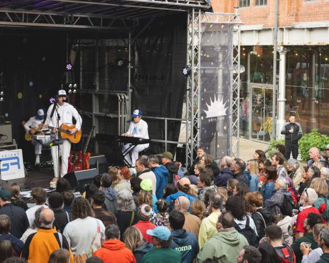 A crowd watching a band at Gwyl Tawe