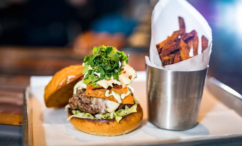 A Cheeseburger with a side of sweet potato fries from Farmer & the Cow.