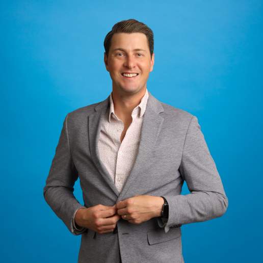 Jason Abady's headshot on blue background