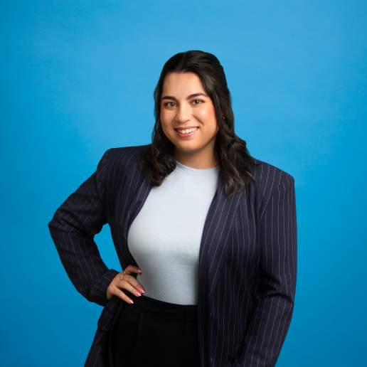 Grace Dearing headshot on blue background