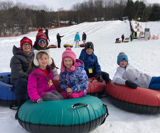 Kids snowtubing in winter