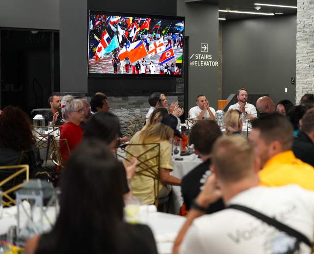 Crowd watching video at Sports Tourism Summit