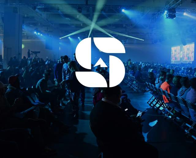 A meeting room with spotlights with the Summit S logo on top