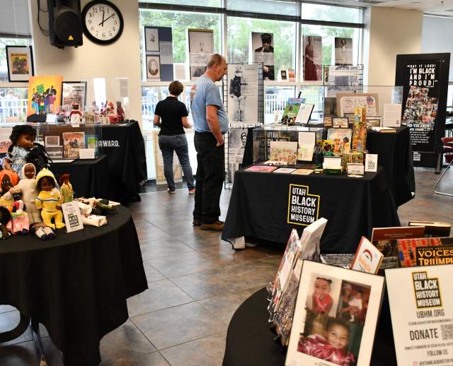 People browsing the Utah Black History Museum exhibit