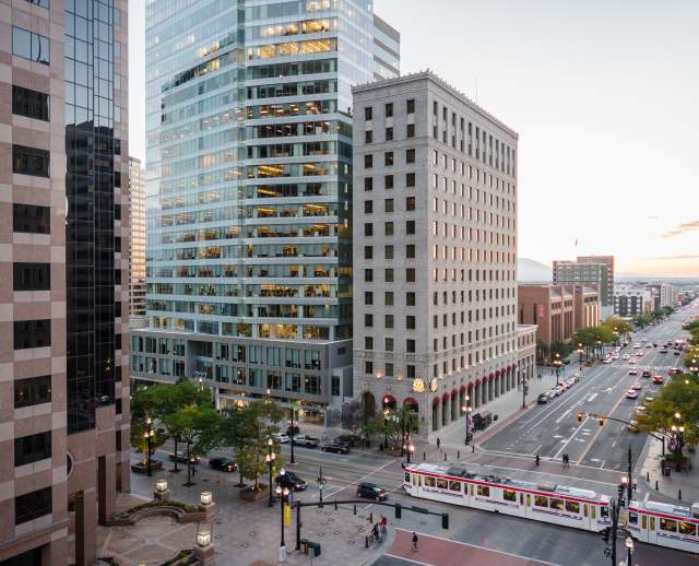 View of Salt Lake City main street with Trax light rail on the street and and early sunset sky