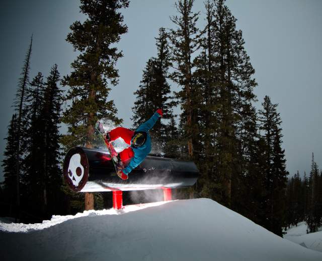 Snowboarder riding a large skullcandy pipe at Brighton resort