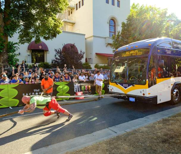 Man pulling a bus at the World's Strongest Man competition