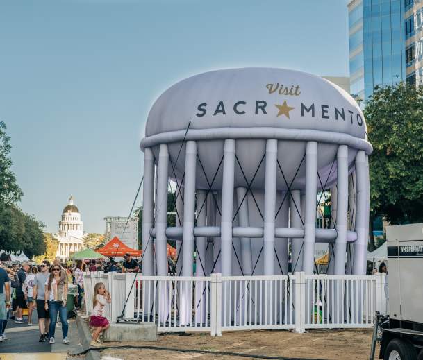 crowd and inflated water tower at farm to fork festival