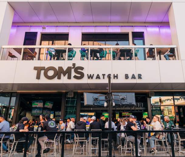 People watching a sports game at Tom's Watch Bar in DOCO