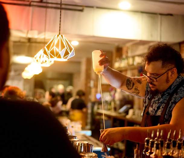 This is an image of a bartender making a craft cocktail at the Archives Bar. A vintage arcade bar in Burlington, VT