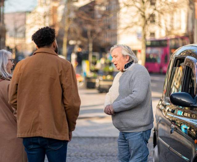 Billy Scott greets his tour group for the Belfast Black Cab Tour
