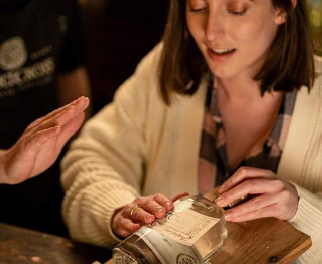 Lady making a label as part of the tour at Shortcross Gin