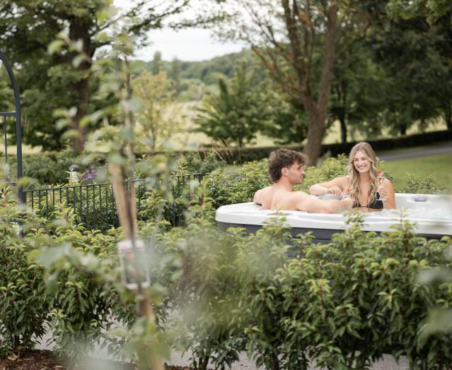 Couple in a hot tub at Roe Valley Resort, County Londonderry.
