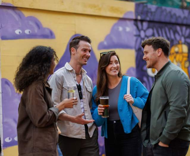 2 couples standing in front of street-art