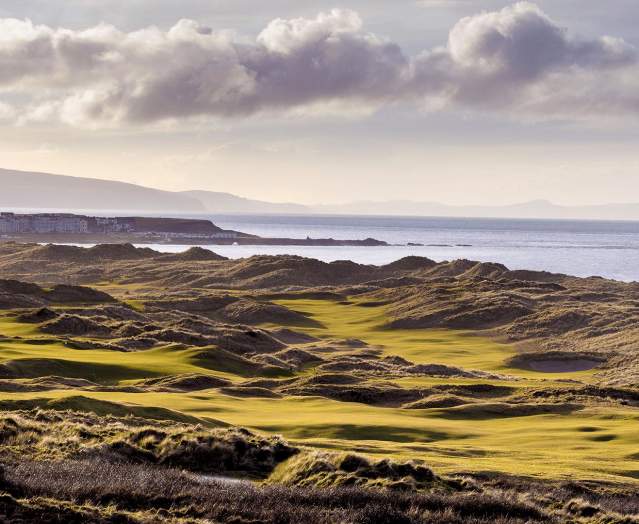 Aerial of the greens and fairways at Royal Portrush Golf Course overlooking the sea