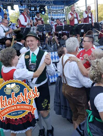 Dancing people at Oktoberfest keg tapping _ with logo