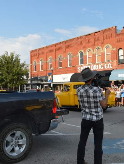 Film crew filming a staged parade in downtown McKinney