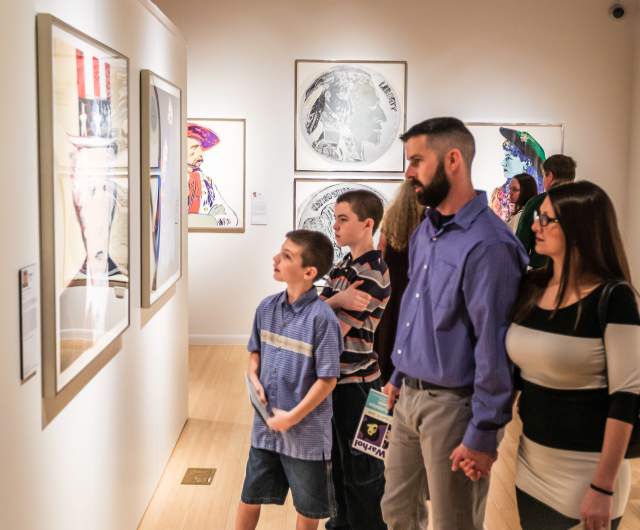 A family of four with two young sons viewing the display at a Cumberland County art gallery.