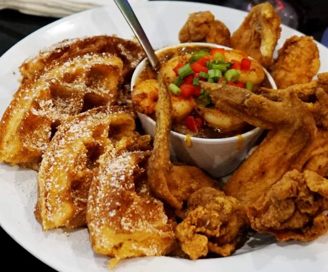a plate of belgian waffle quarters with fried chicken