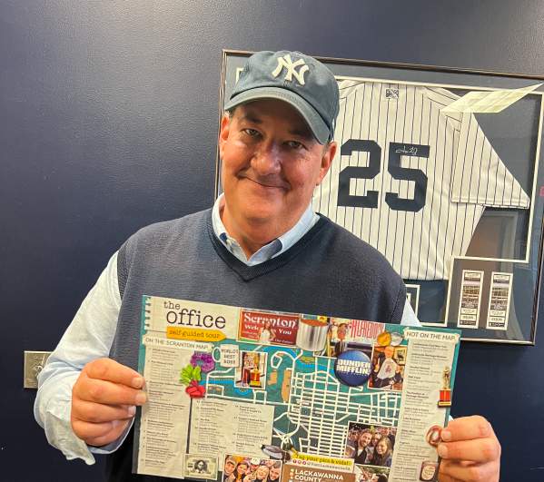 Brian Baumgartner (aka Kevin from The Office tv show) holding The Office Self-Guided Tour map
