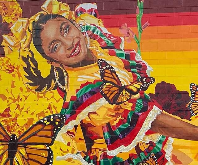 mural of dancers in traditional dresses with butterflies