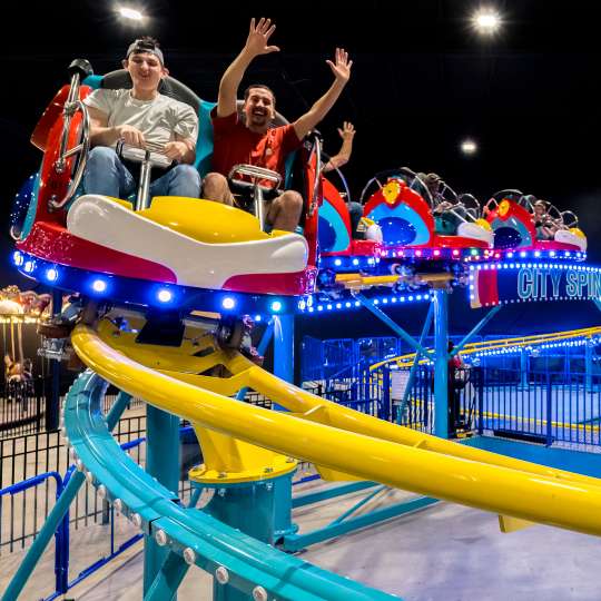 family on an indoor roller coaster
