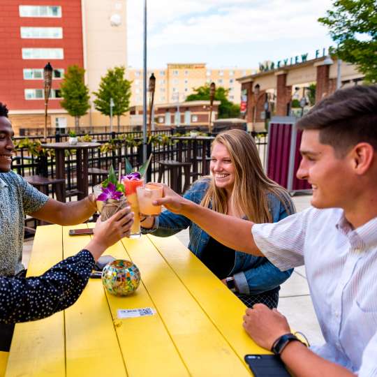 Young adults enjoying drinks at the Sidecar outdoor bar in downtown Fort Wayne.