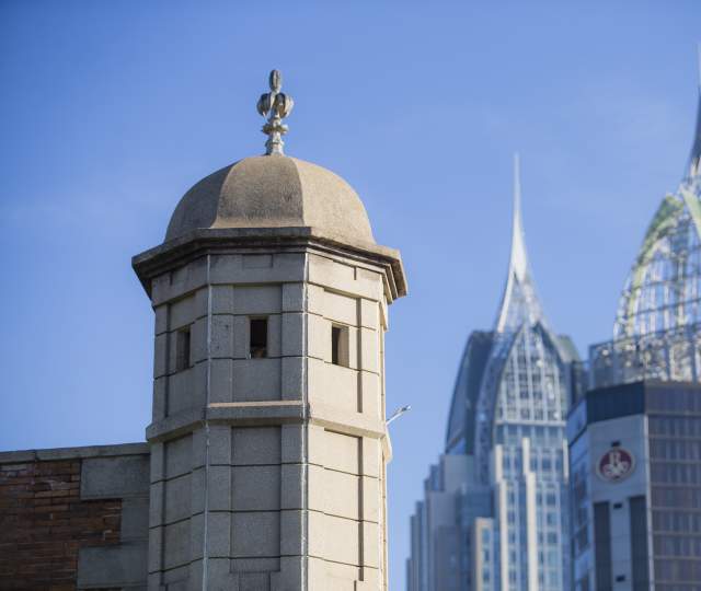 Spire of Colonial Fort Condé with sky scrapers in the background in Mobile, AL