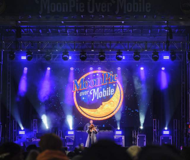 Performer on a purple lit stage with Moonpie logo
