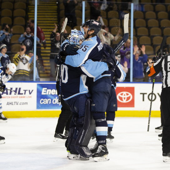 Admirals players hugging and cheering
