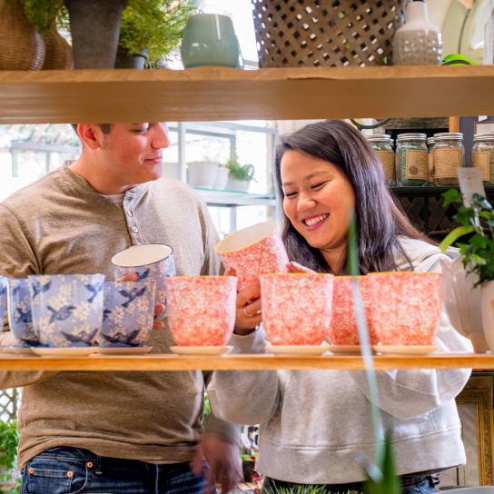 couple looking at colorful plant pots