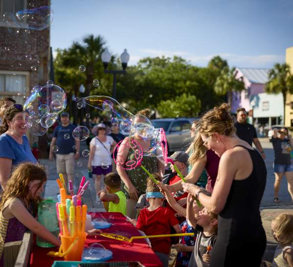 Blowing bubbles at Brunswick's First Friday