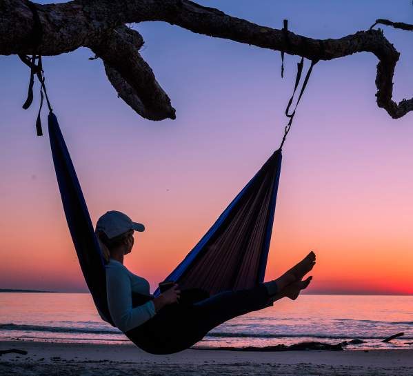 Woman in hammock at Driftwood Beach