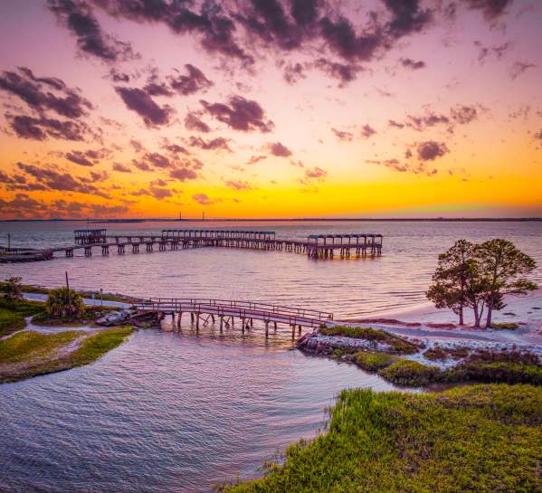 The Jekyll Island Fishing Pier is a popular place to watch the sunset on Jekyll Island, GA