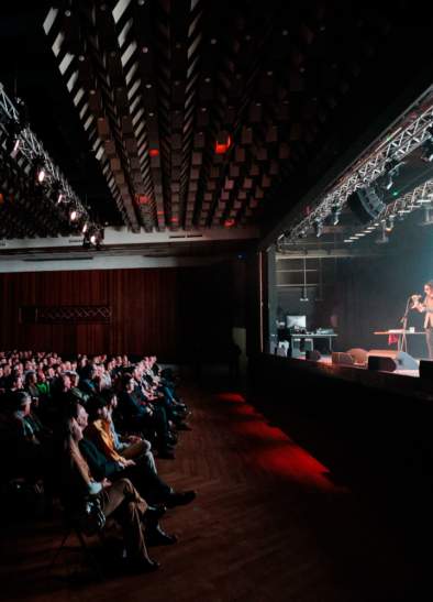 Comedian on stage at New Century Hall