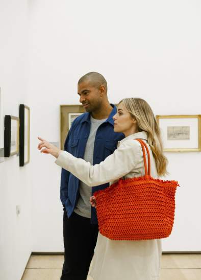 2 people in art gallery looking at photo