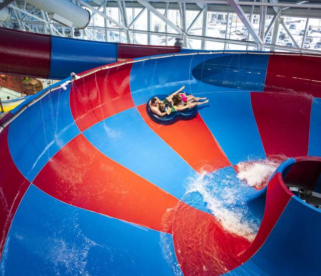 family tubing down one of the water slides located at Watiki Waterpark in Rapid City,sd