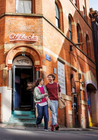 Exterior shot of a couple outside of Afflecks in the Northern Quarter.