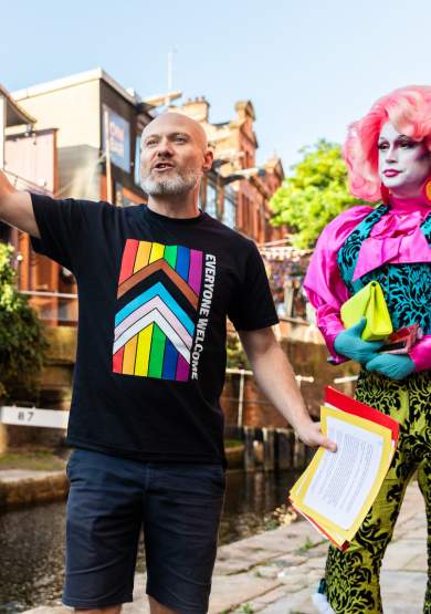 Tour guide on Manchester's Canal Street delivering LGBT tour of the city