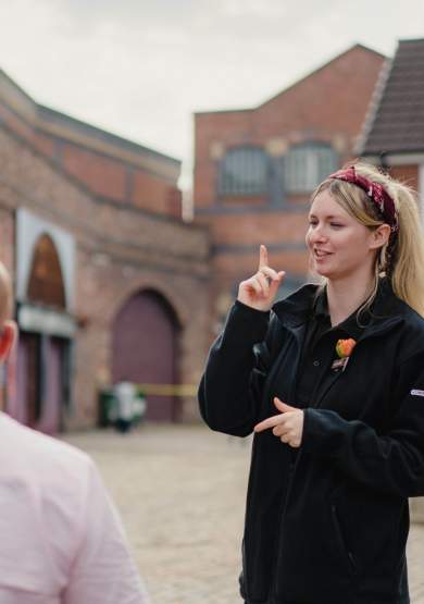 Guide on Coronation Street Tour set with visitors