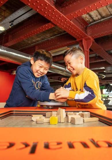Two children playing with exhibit at Science and Industry Museum