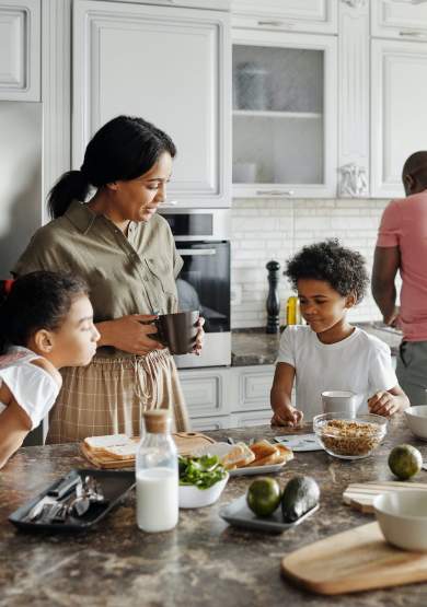 Family cooking in kitchen with food on counter