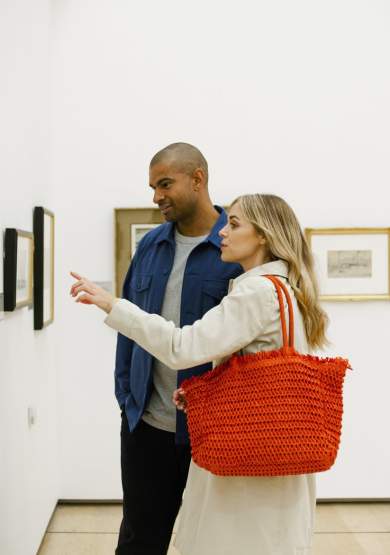2 people in art gallery looking at photo
