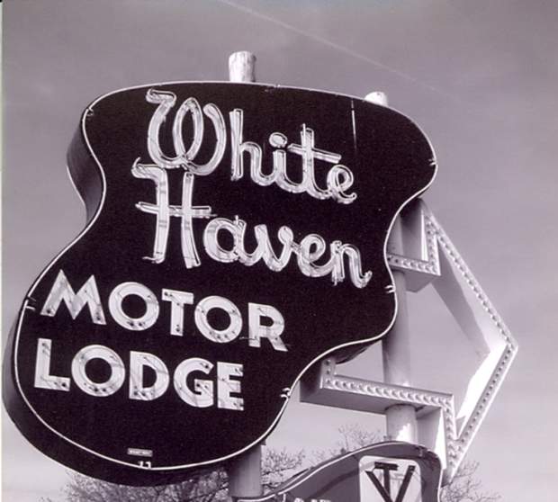Black and white photograph of the White Haven Motor Lodge sign in Overland Park