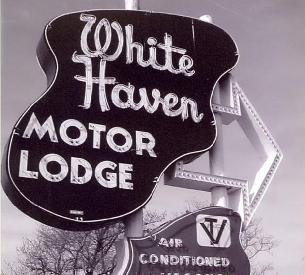 Black and white photograph of the White Haven Motor Lodge sign in Overland Park